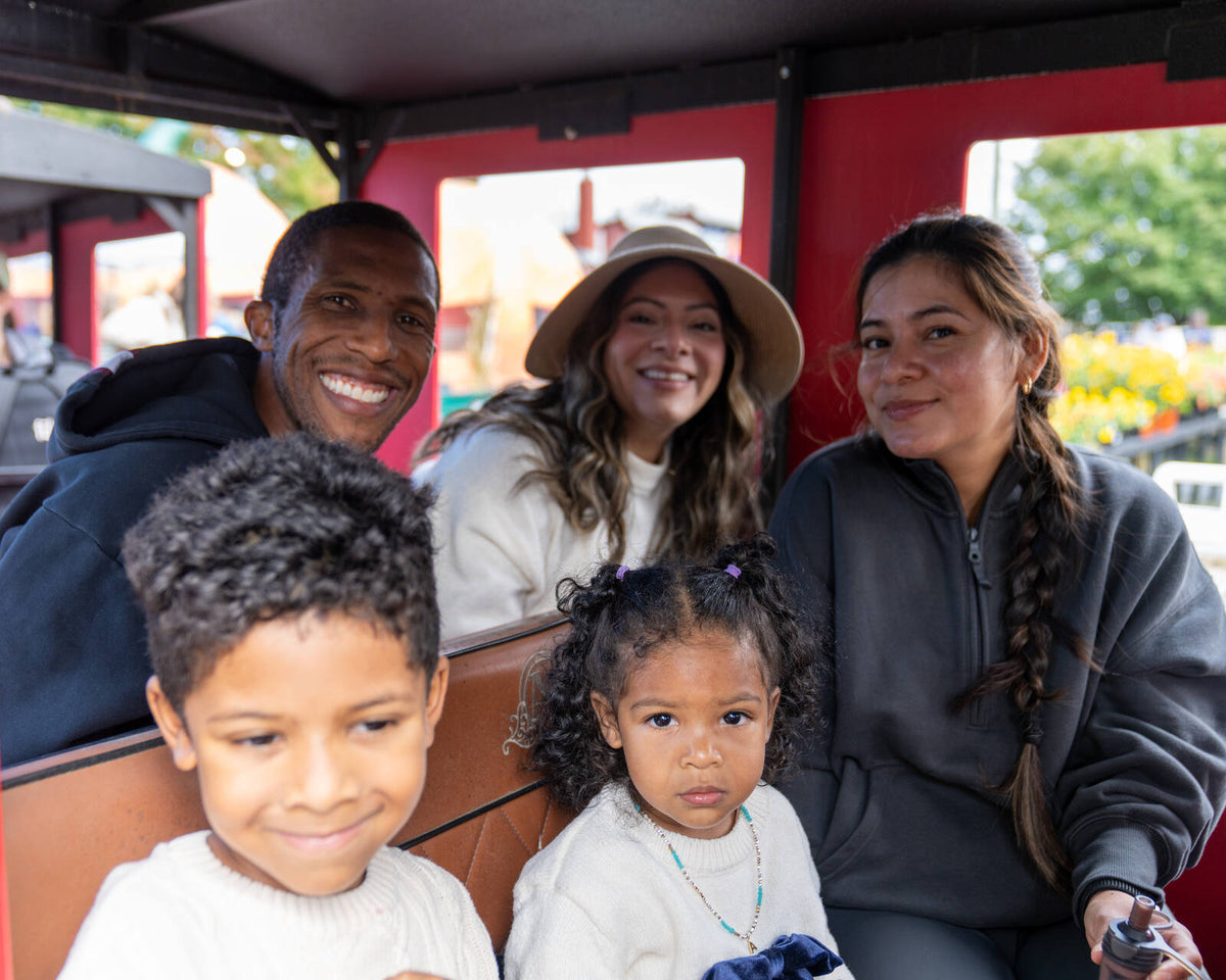 A family riding the train at Reston Farm's Fall Fun Fest