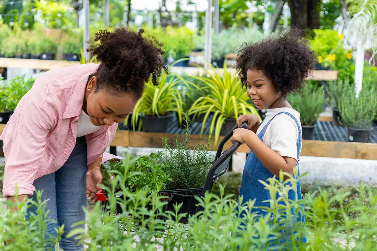 Mom and daughter shopping at garden center.